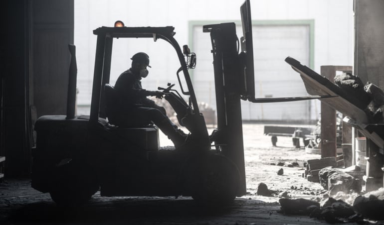 Construction worker on forklift - clearing debris