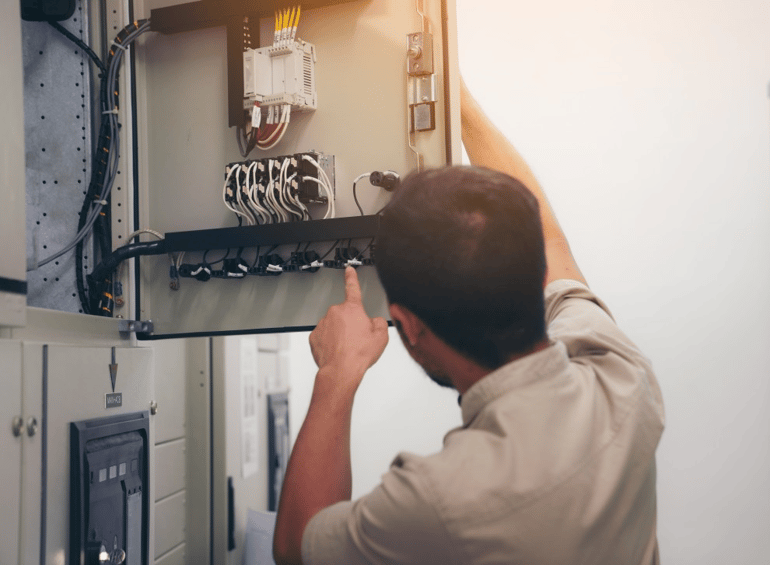 electrical-engineer-man-checking-voltage-and-test-at-the-power-distribution-cabinet-in-the-control_t20_E0dZAZ