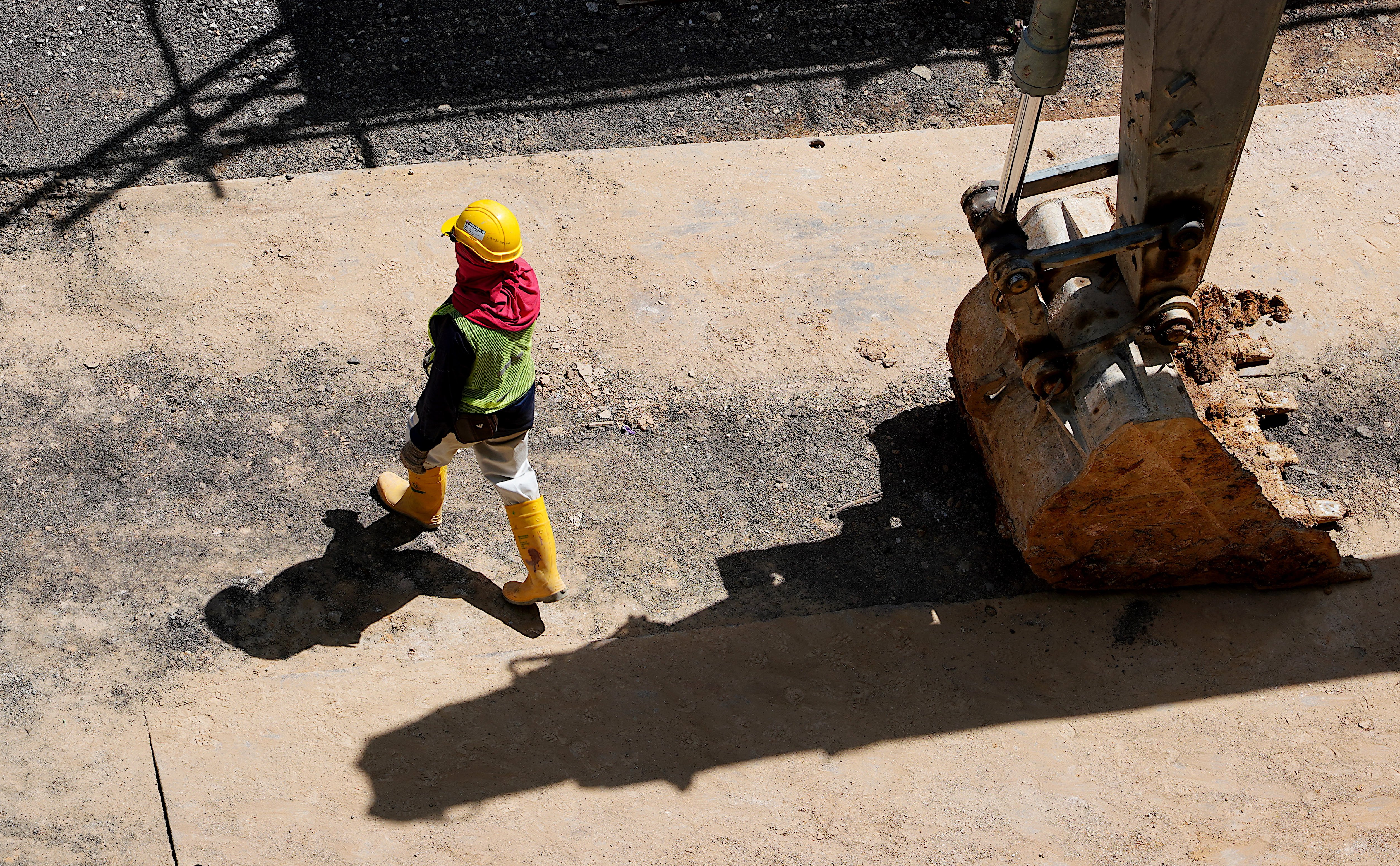 Canva - High Angle Photo of Person Walking Near Backhoe