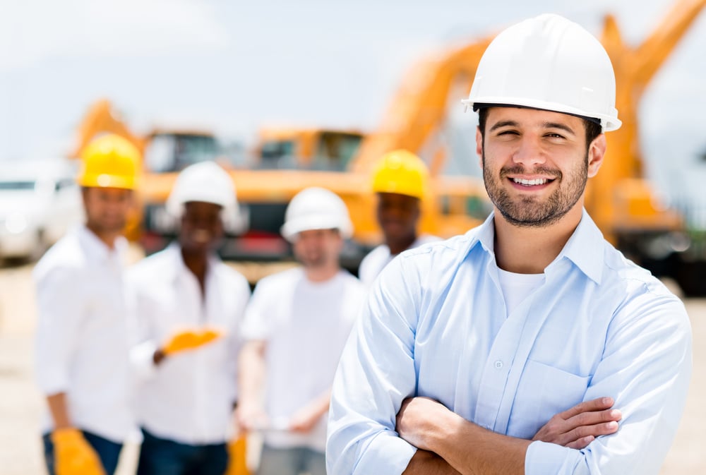 Successful male architect at a building site with arms crossed